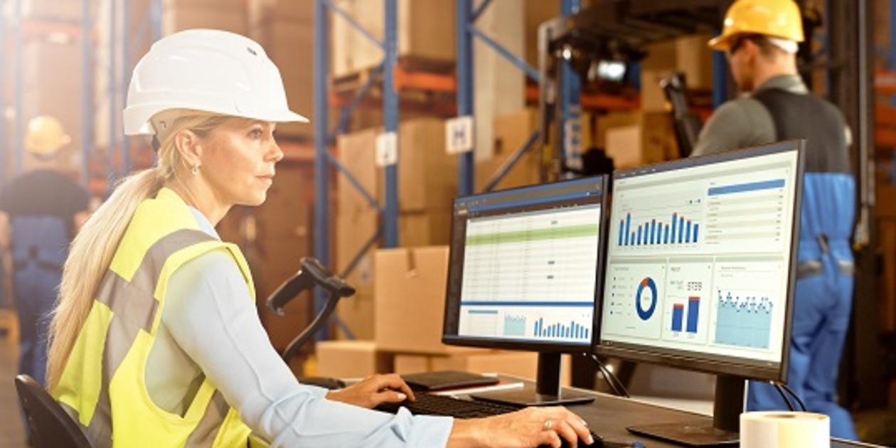 Woman wearing a hard hat at desk