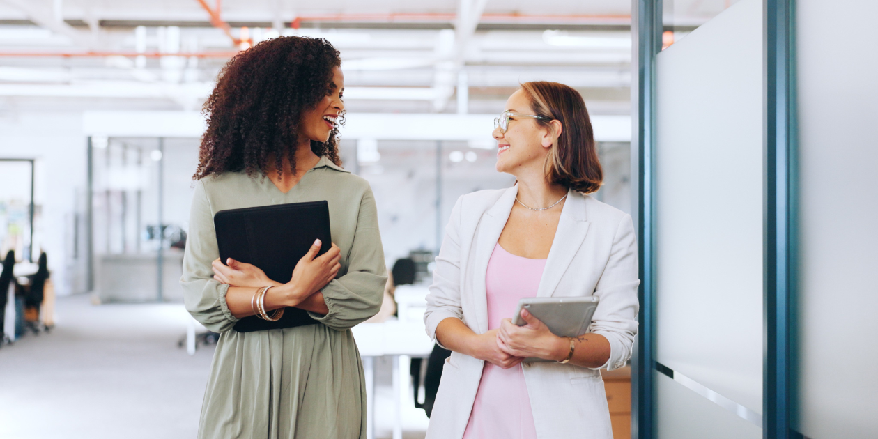 Two professional women conversing in office