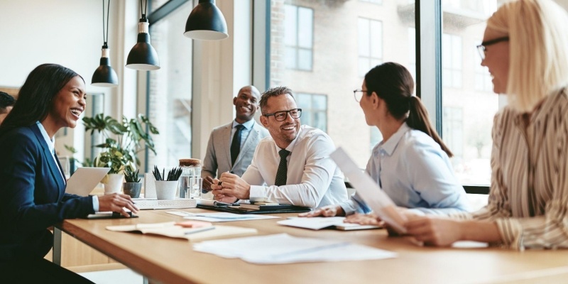 Colleagues discuss EDI technical evolution in a bright office setting