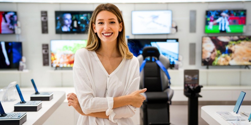 Smiling woman standing in front of technology.
