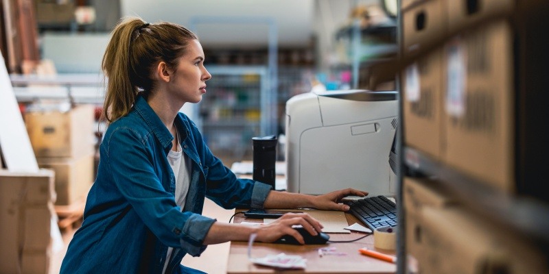 Woman at work using a desktop computer.