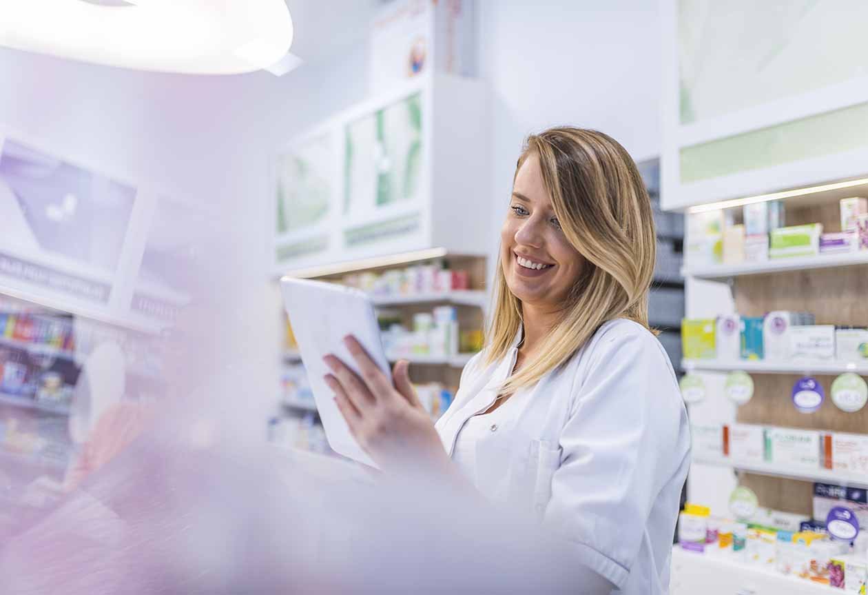 A photograph of a pharmacist enabled by a data exchange process delivered by a Remedi consultant team using the integration platform from Remedi software partner Seeburger.